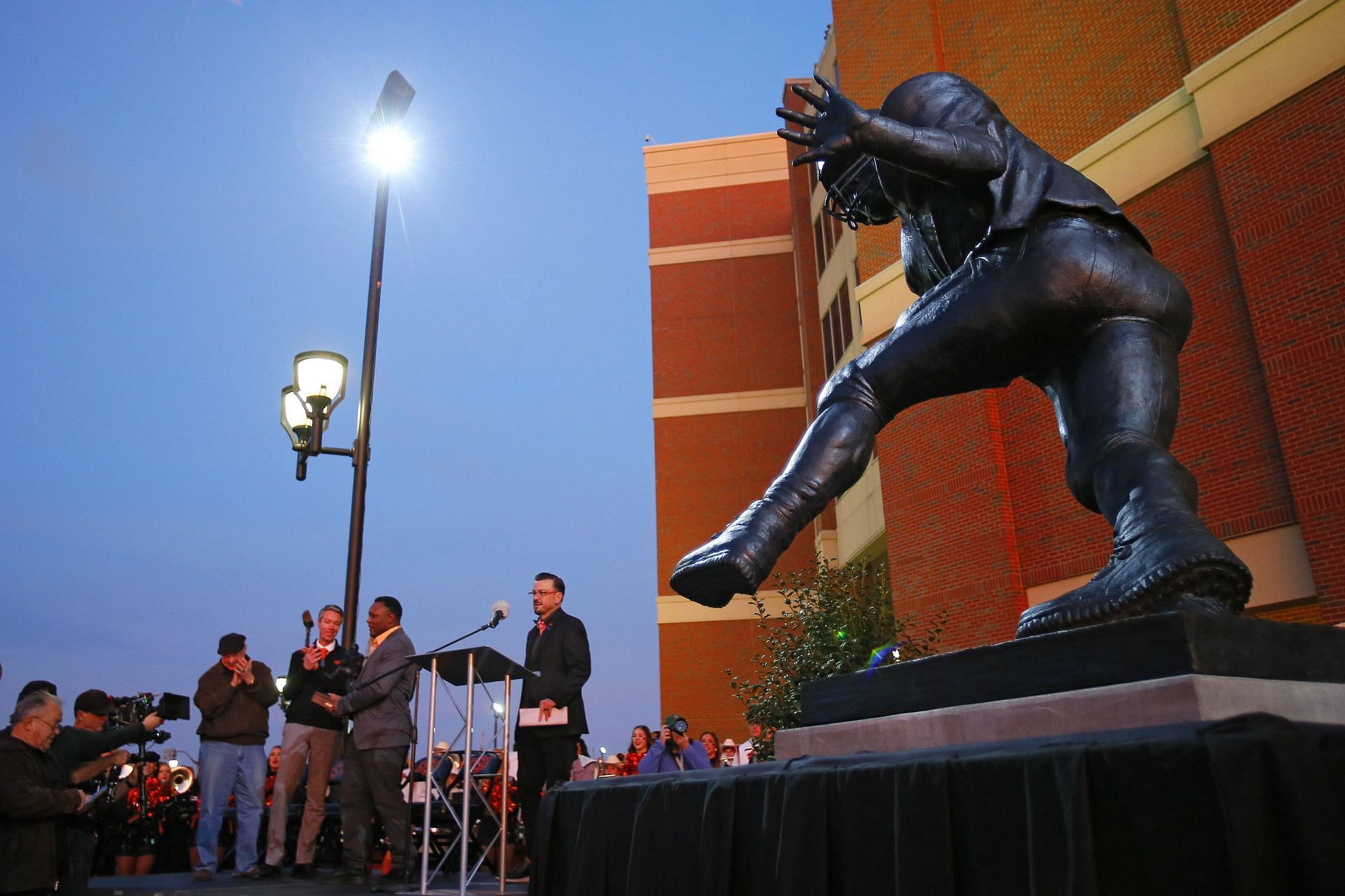 Barry Sanders stands on the podium after a statue was unveiled in his honor by the Oklahoma State Cowboys at Boone Pickens Stadium