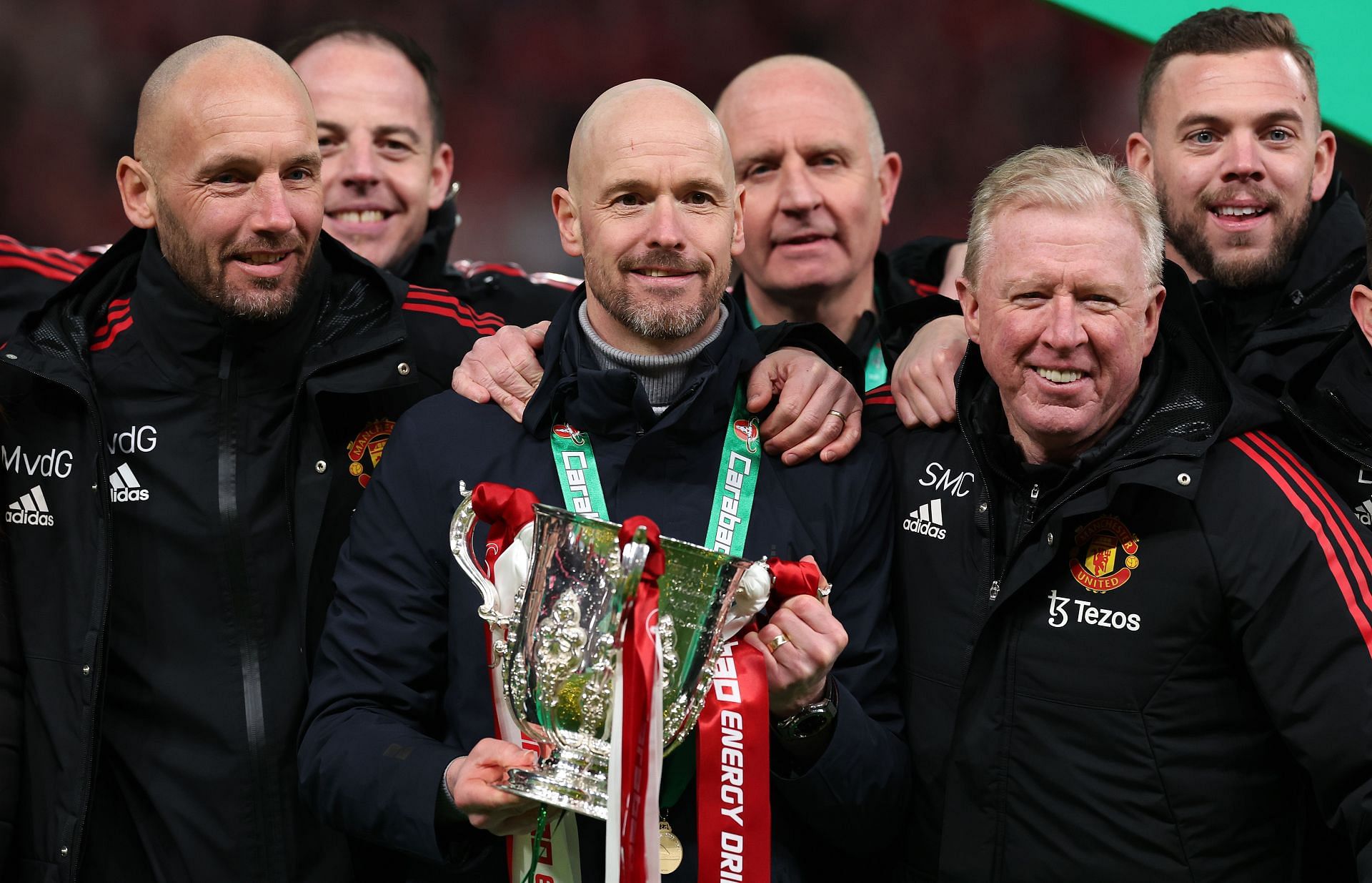 Manchester United manager Erik ten Hag (C) and his backroom staff celebrate the club&#039;s Carabao Cup win.