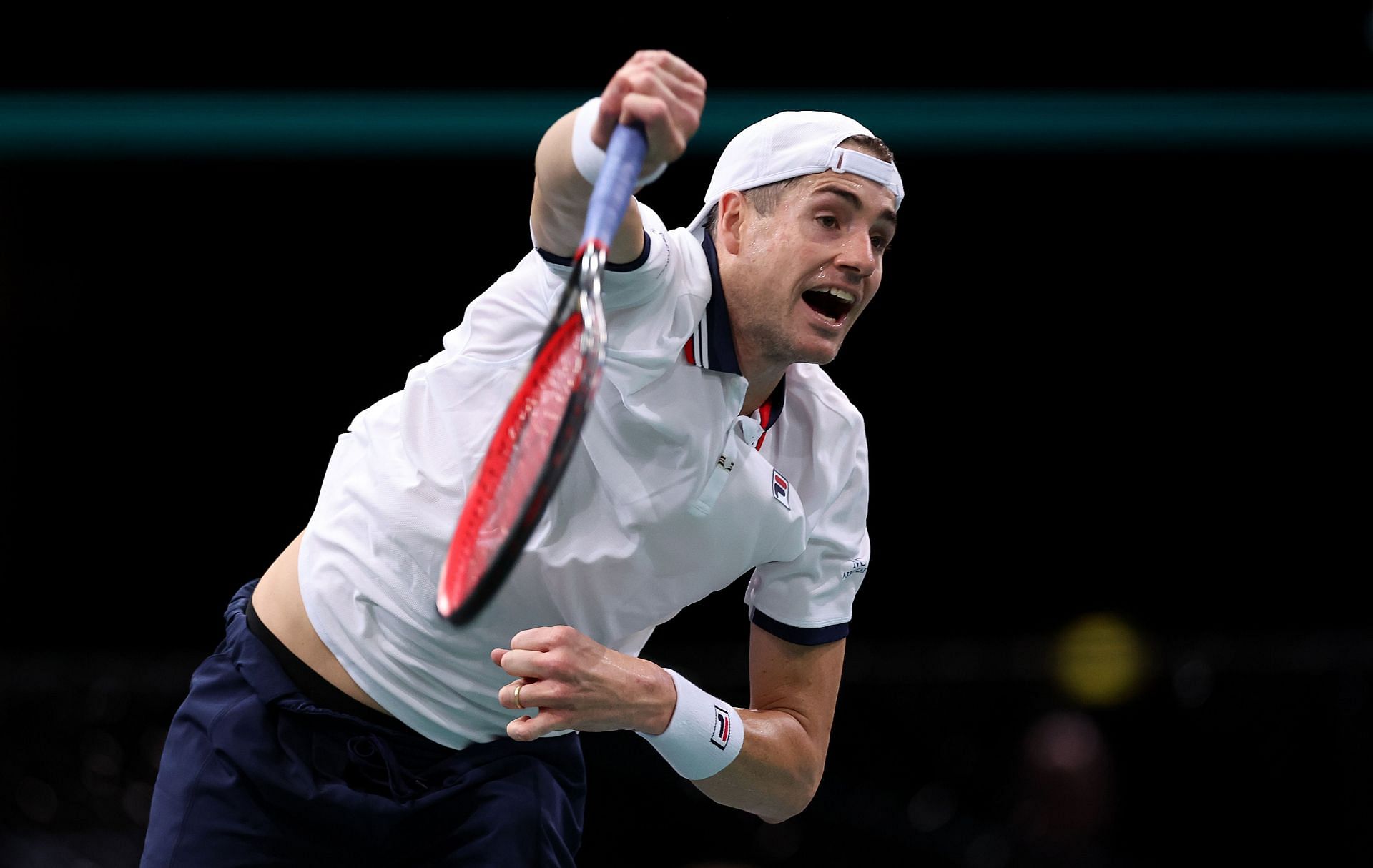 Isner serves at the Rolex Paris Masters