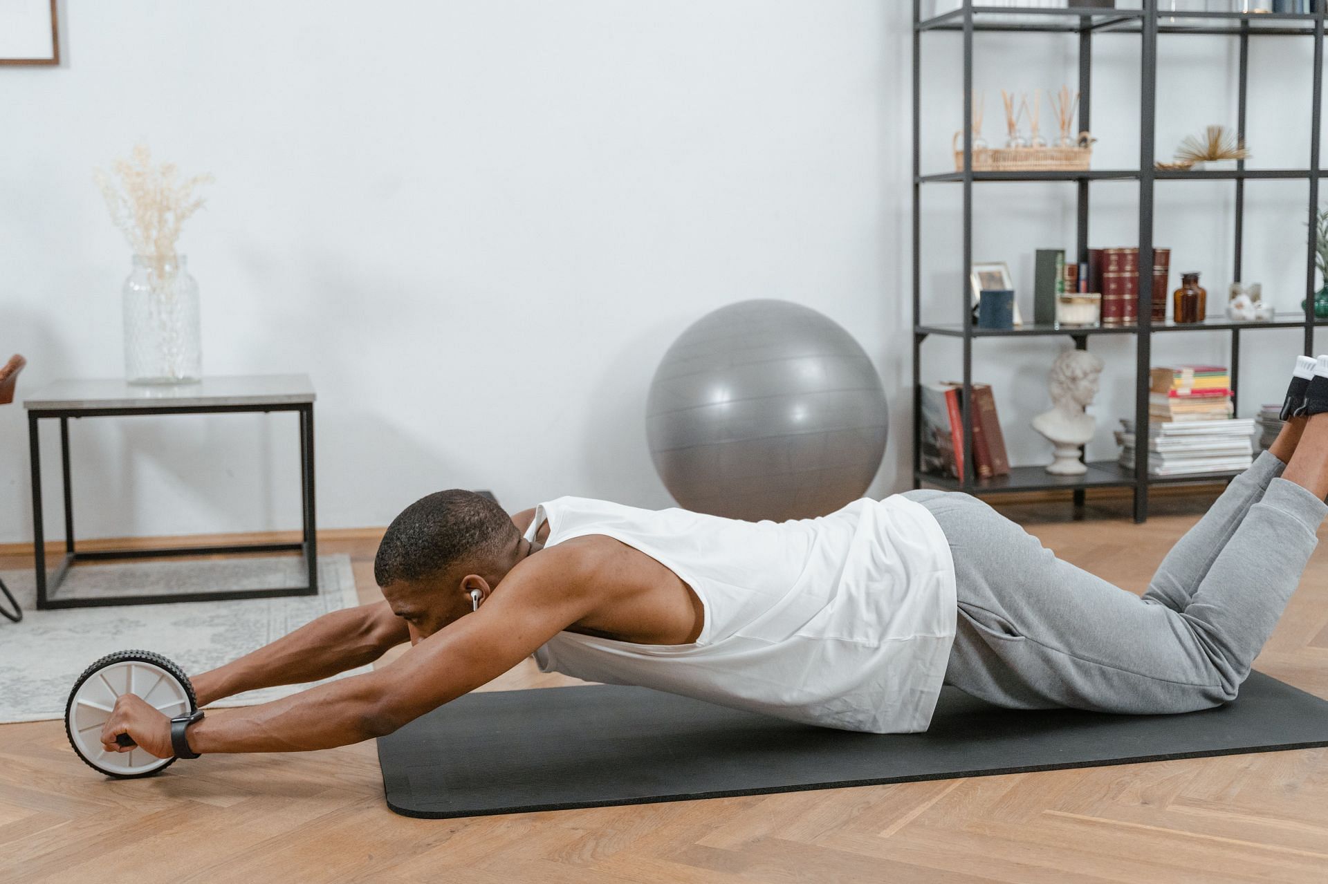 Choose a non-slippery surface for ab roller exercises. (Image via Pexels/Mart Production)