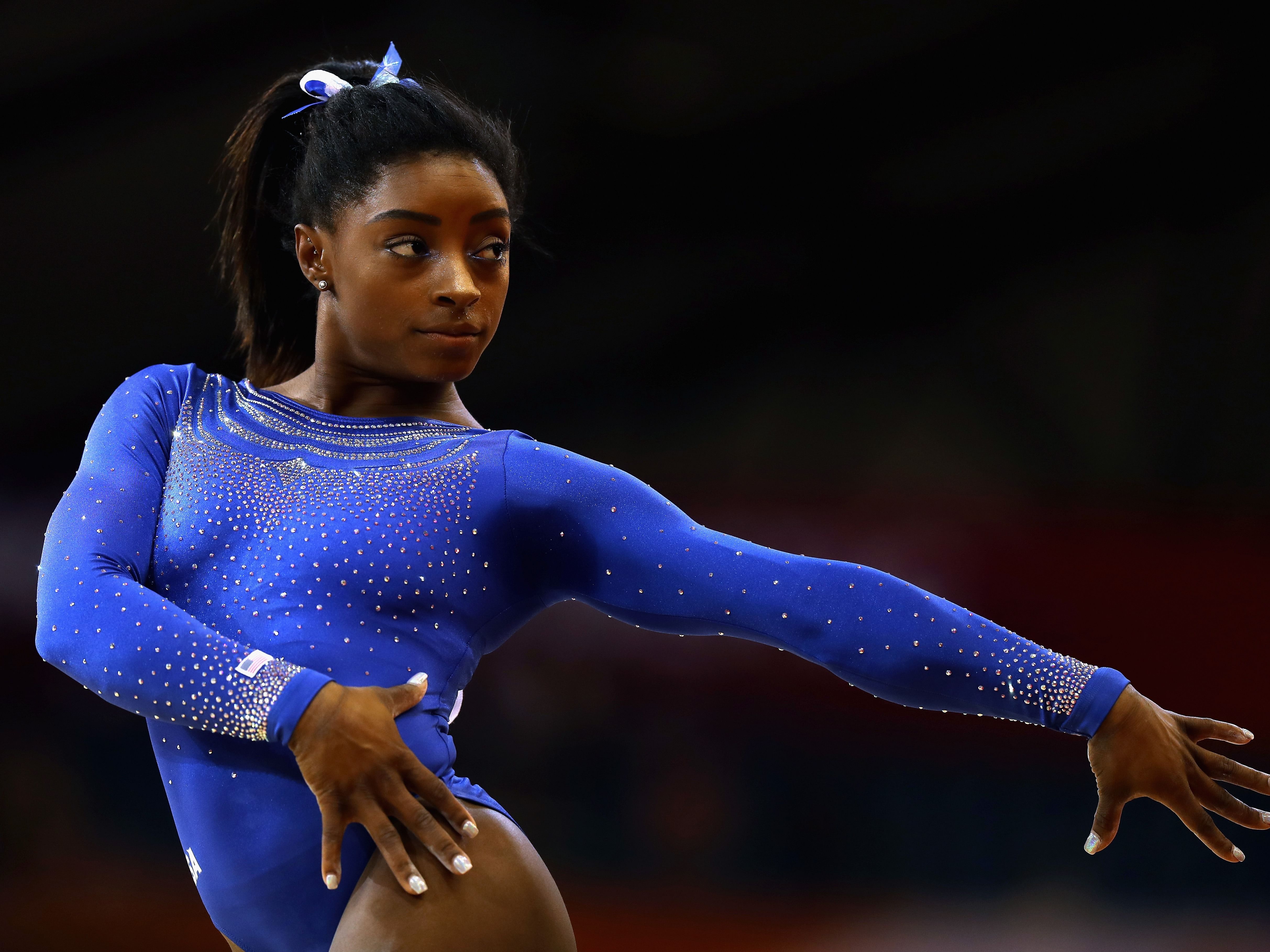 Simone Biles performing her routine (via getty images) 