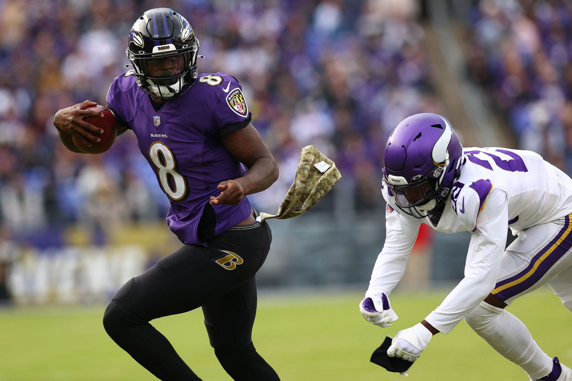 Lamar Jackson of the Baltimore Ravens wipes his face during a time