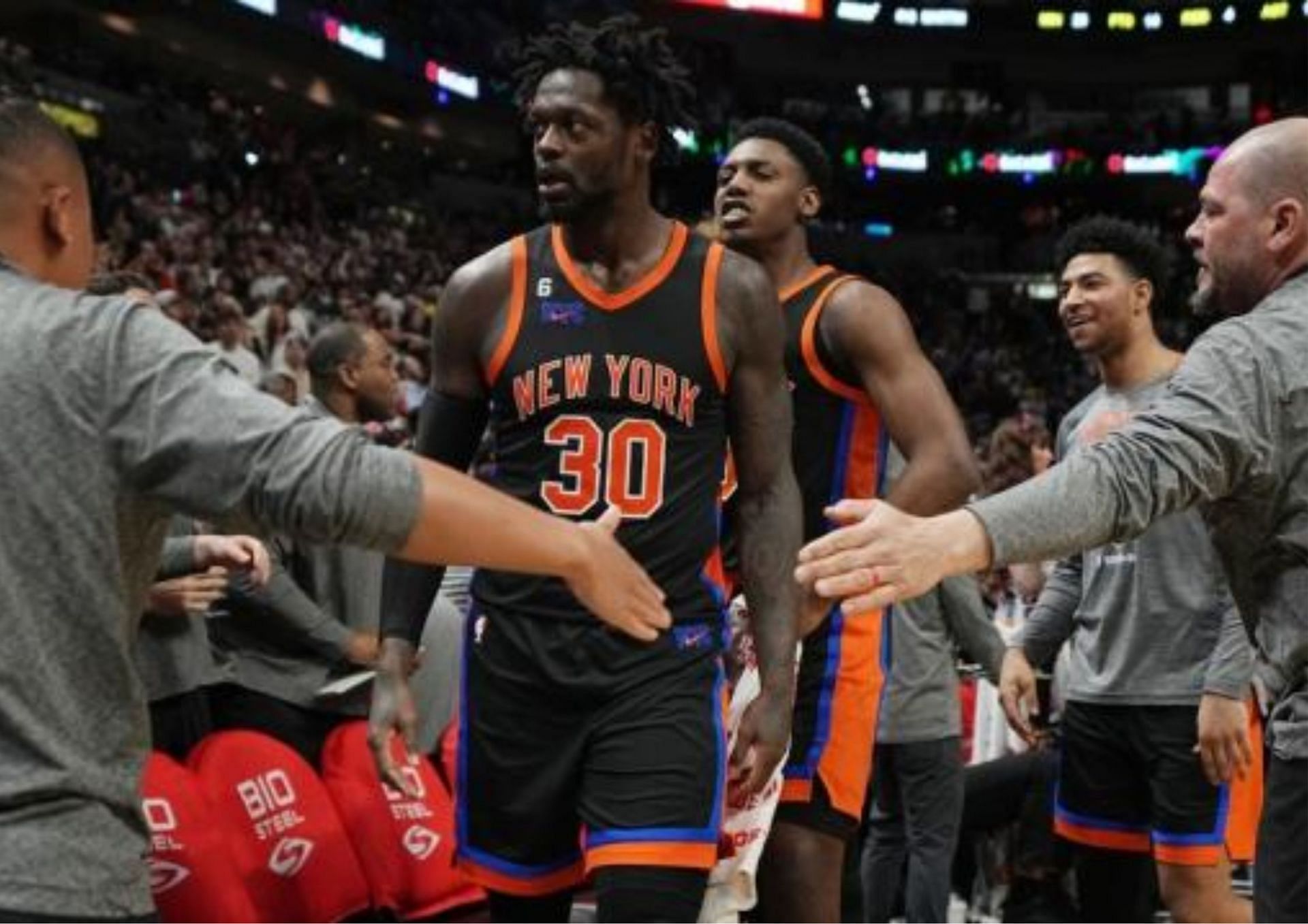 Julius Randle is mobbed by teammates after a dagger three-pointer pushed the New York Knicks to a 122-120 win over the Miami Heat. [photo: Yahoo! Sports]