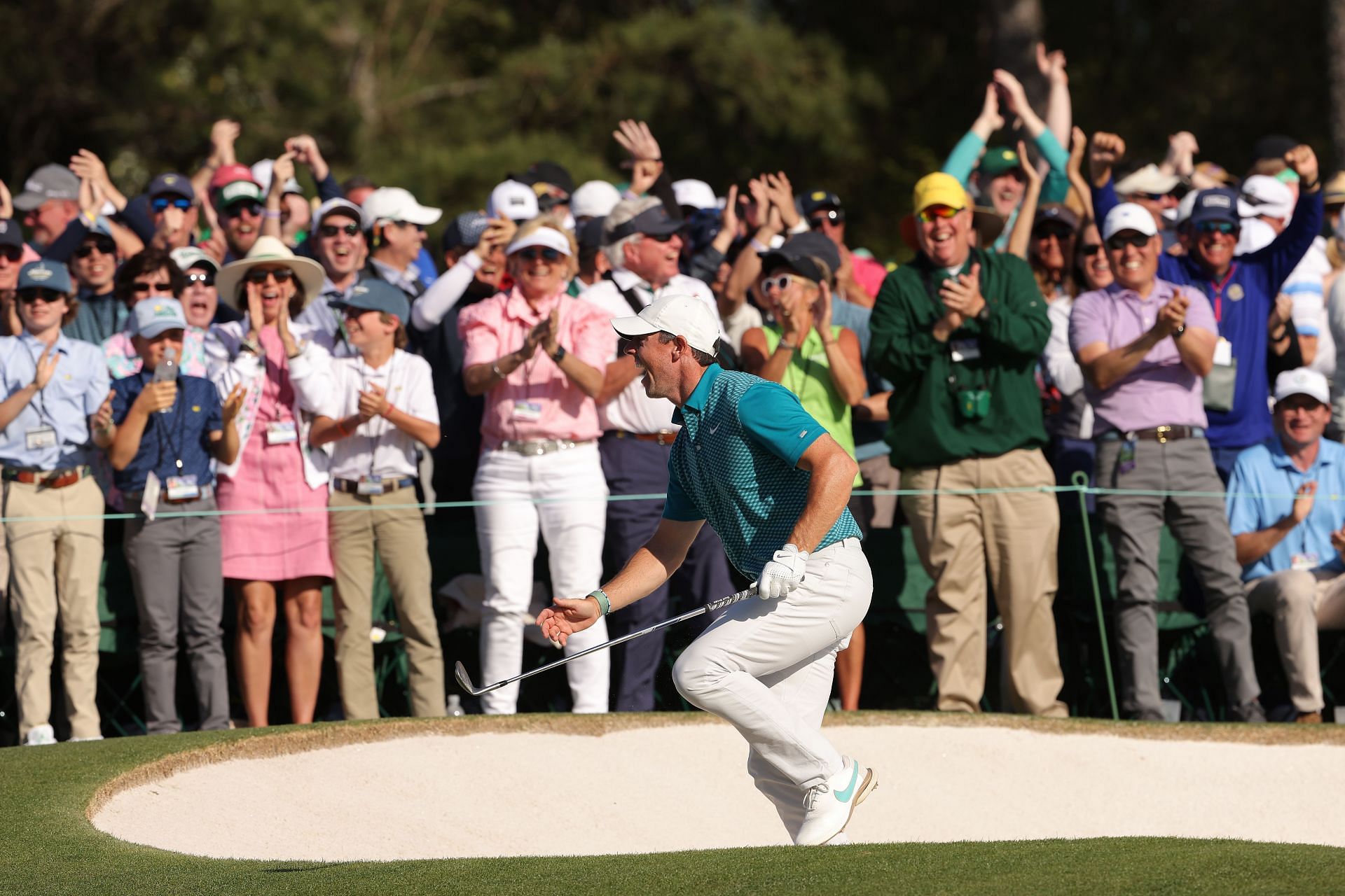Rory McIlroy reacts after chipping in for a birdie from the bunker on the 18th green during the final round of the Masters