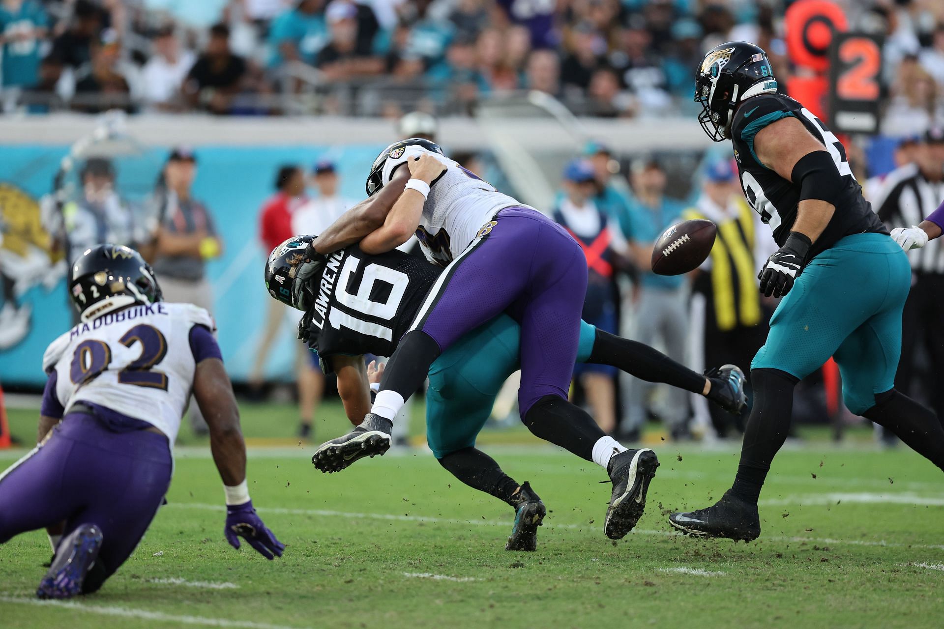 Calais Campbell #93 sacks Trevor Lawrence #16 of the Jacksonville Jaguars 