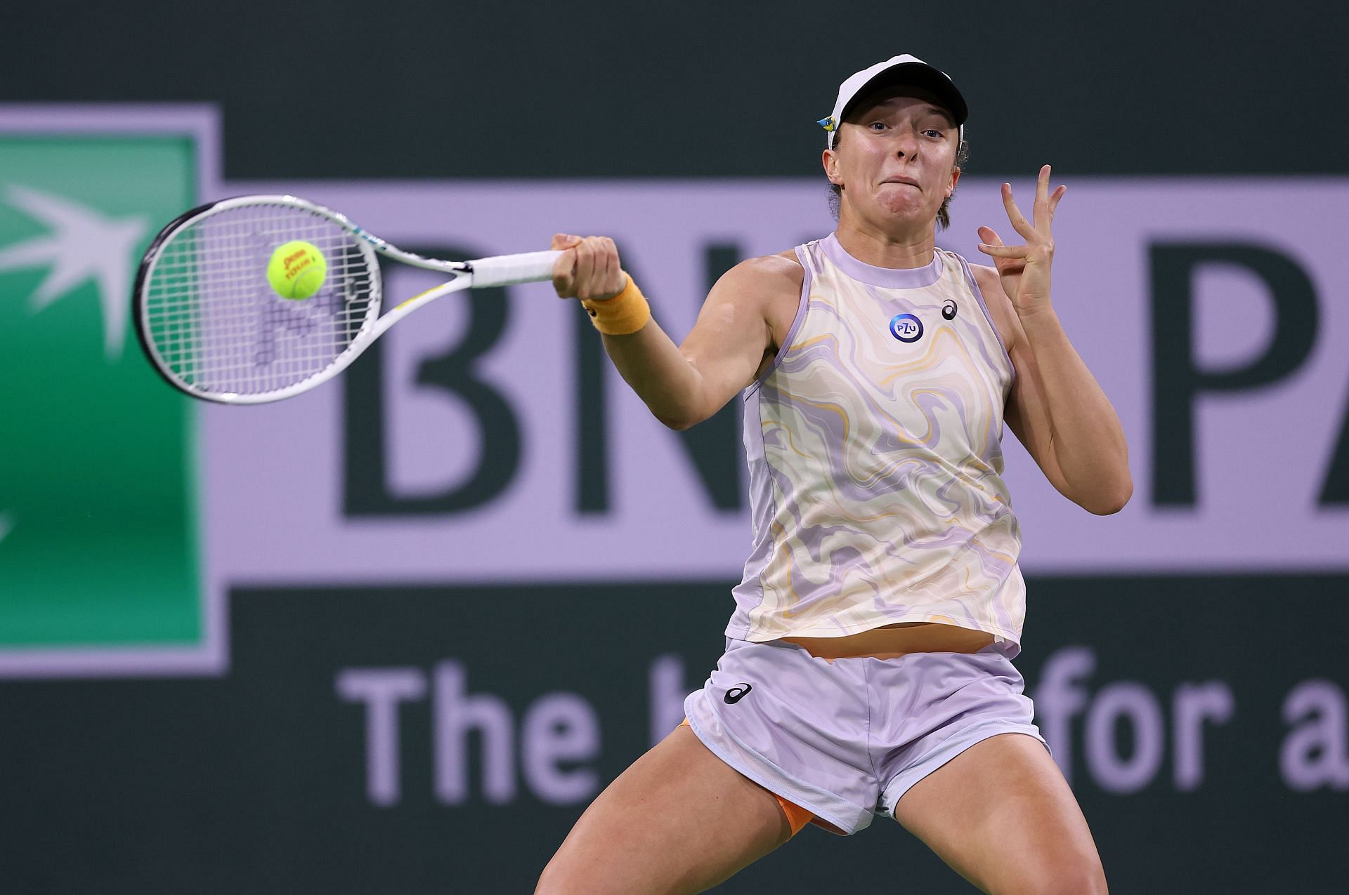 Iga Swiatek competes during her match against Emma Raducanu at Indian Wells 2023.