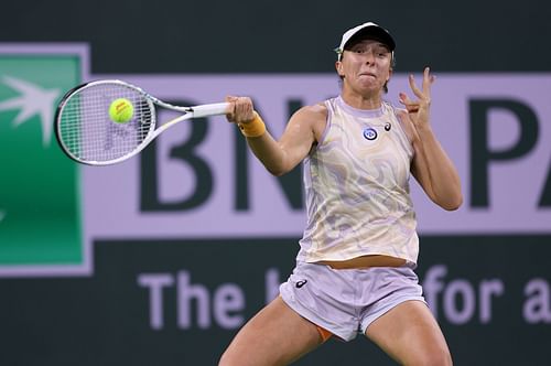 Iga Swiatek competes during her match against Emma Raducanu at Indian Wells 2023.