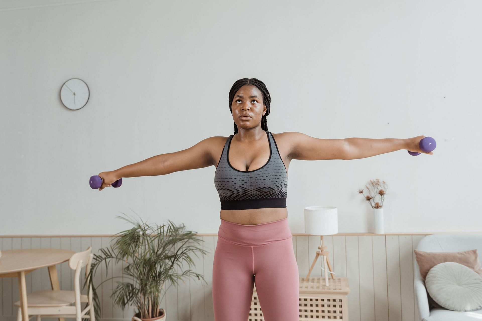 Lateral raises help to strengthen your lateral and anterior delts (Image via Pexels @Mart Production)