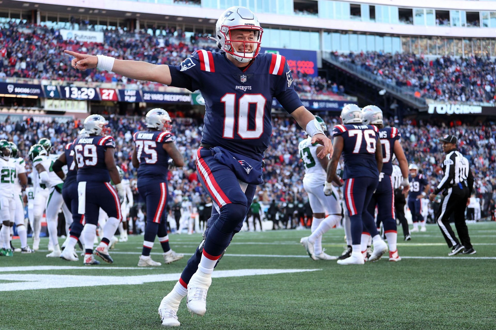 Mac Jones #10 of the New England Patriots celebrates a touchdown in the second half against the New York Jets