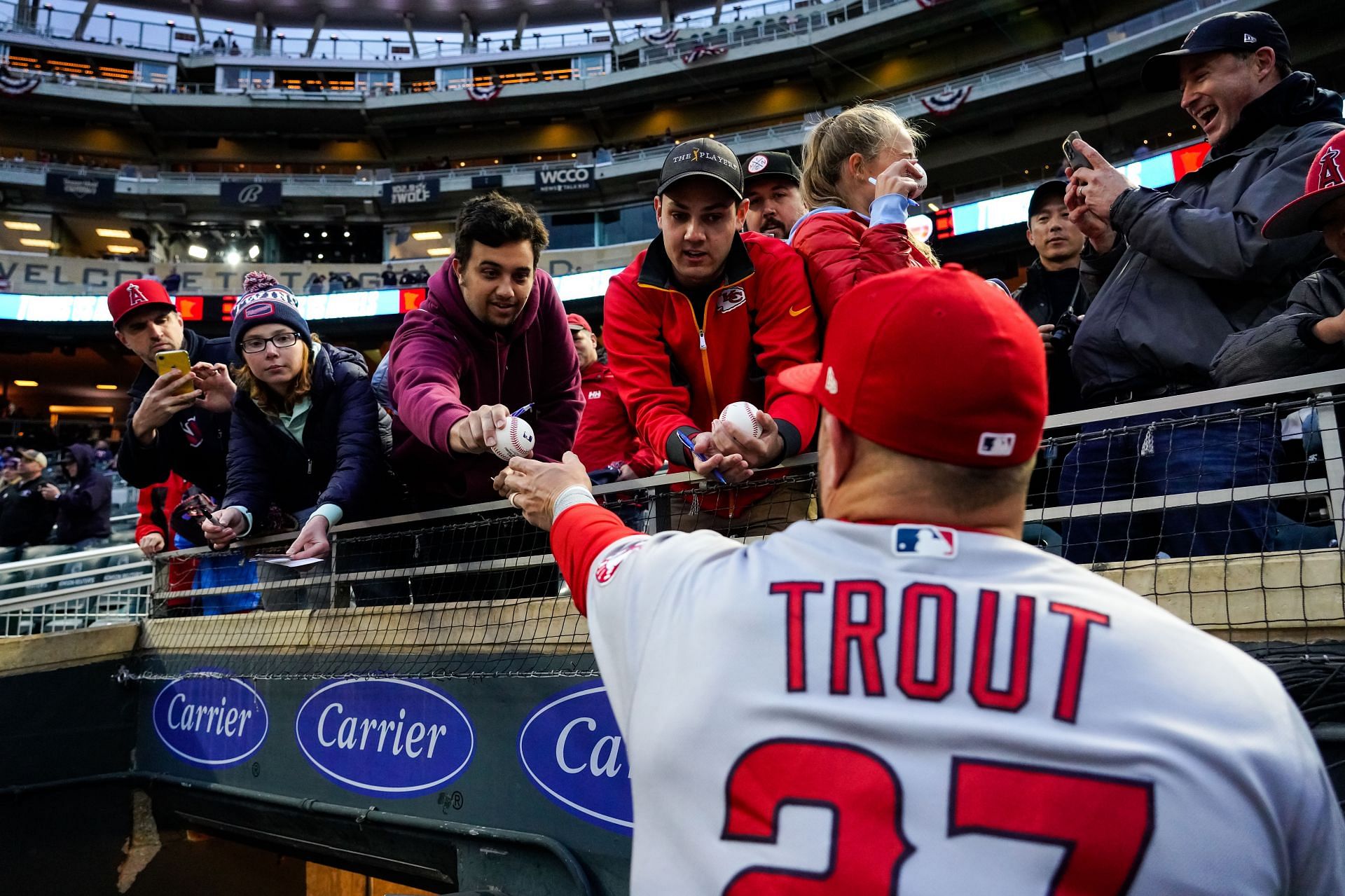 Mike Trout of the Los Angeles Angels signs autographs for fans at Target Field in Minneapolis, Minnesota