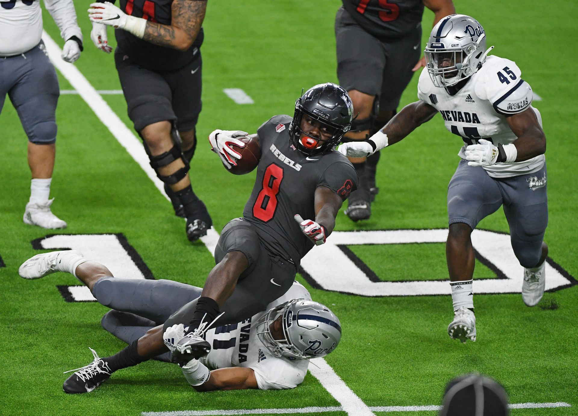 Daiyan Henley makes a tackle - Nevada v UNLV