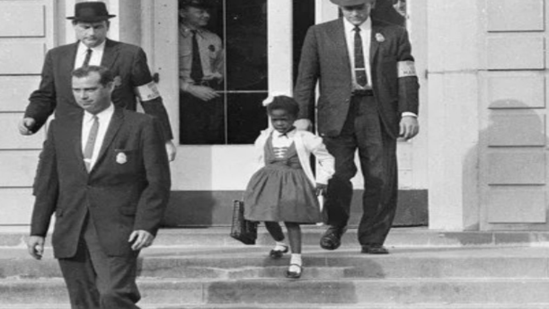 Ruby Bridges (6) being escorted by federal marshalls to a all white shool in New Orleans in 1960 (Image via Nick Covington/twitter)