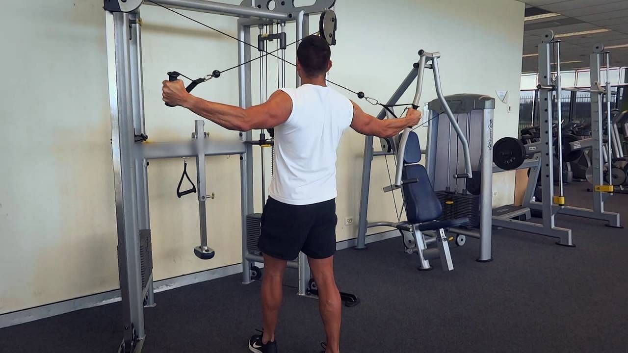 The High Cable Rear Delt Flye is an exercise that targets the rear deltoid muscles and is performed using a cable machine (Image via Exercises.com.au/ Pexels)