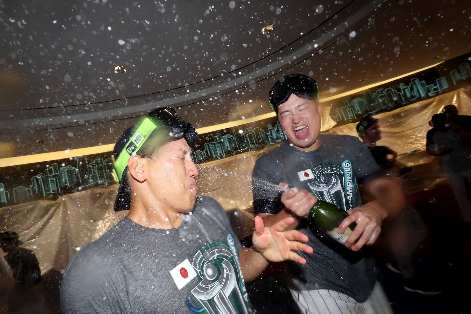 Masataka Yoshida #34 and Munetaka Murakami #55 of Team Japan celebrate in the clubhouse after defeating Team USA in the World Baseball Classic Championship