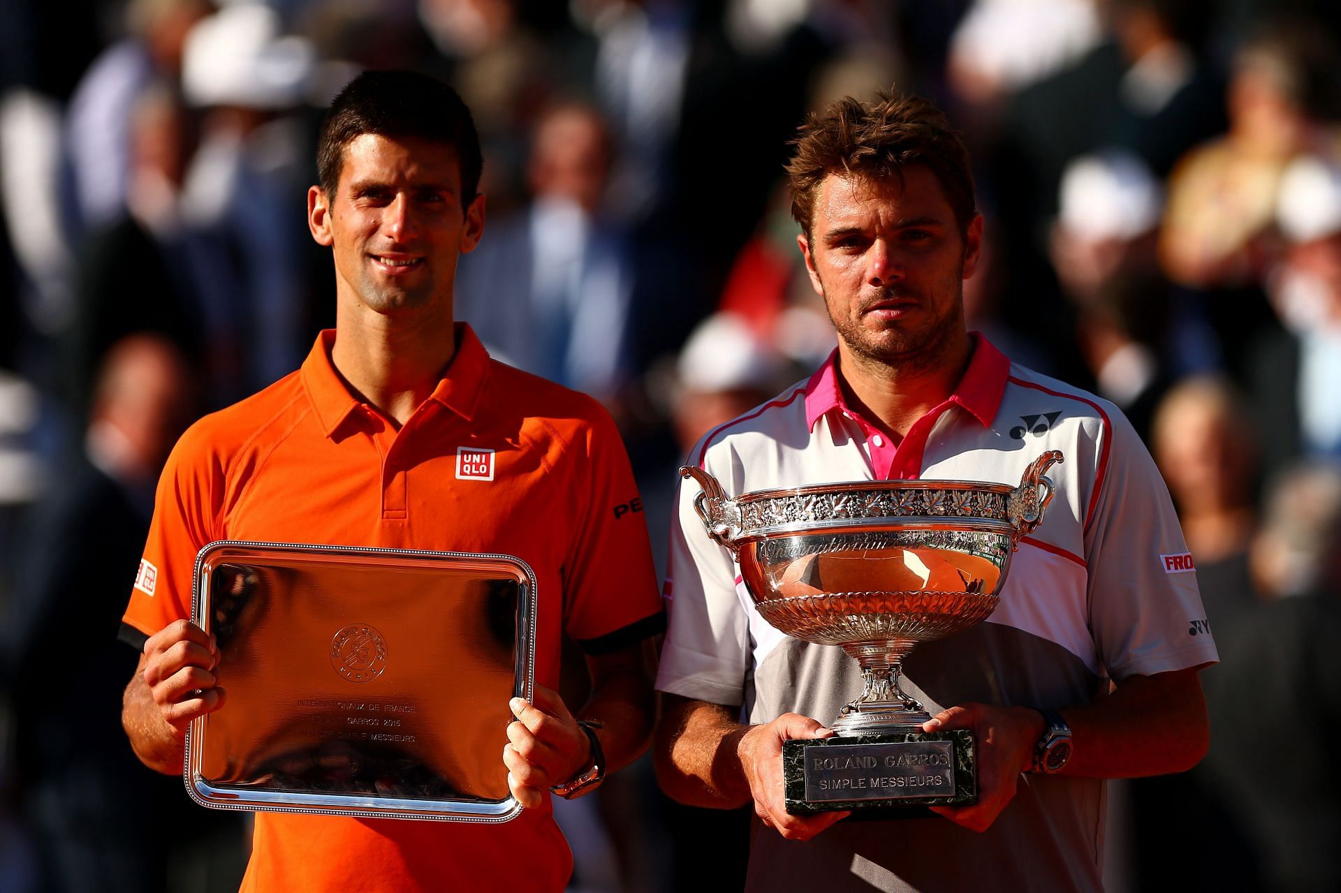 Novak Djokovic (L) &amp; Stan Wawrinka with their trophies after the 2015 French Open final
