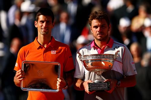 Novak Djokovic (L) & Stan Wawrinka with their trophies after the 2015 French Open final