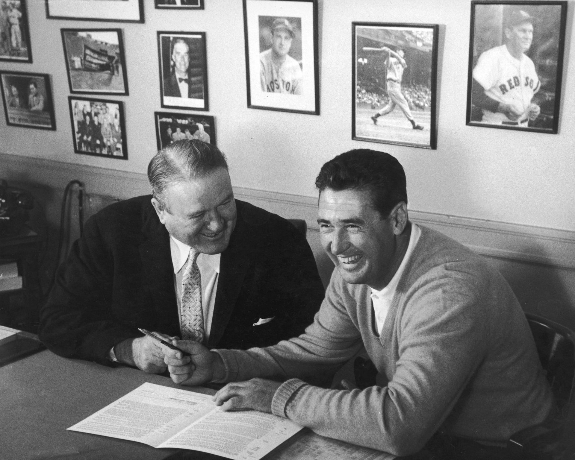 Ted Williams Dies: BOSTON - CIRCA 1955: (UNDATED FILE PHOTO) Baseball legend Ted (1918 - 2002) of the Boston Red Sox (R) signs a baseball contract as Boston Manager Joe Cronin (1906 - 1984) looks on in 1958. The 83-year-old Williams, who was the last major league player to bat .400 when he hit .406 in 1941, died July 5, 2002 at Citrus County Memorial Hospital in Florida. He died of an apparent heart attack. (Photo by Getty Images)