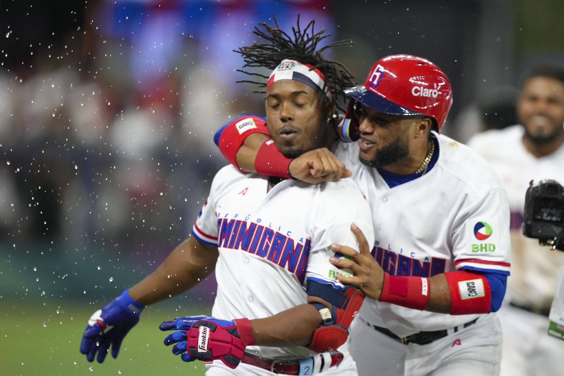 Robinson Cano #24 hugs Jean Segura #2 of The Dominican Republic after his walk off hit to end the game against Israel
