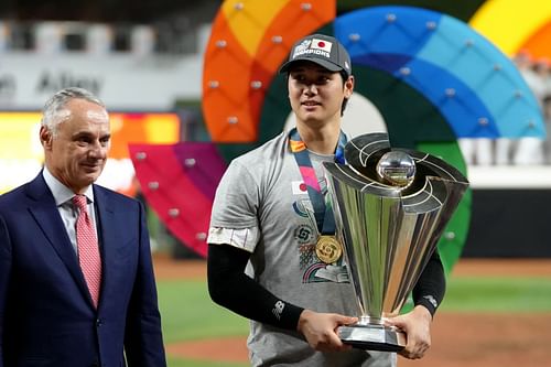 Shohei Ohtani #16 of Team Japan is awarded the trophy by Commissioner of Baseball Rob Manfred (L) after defeating Team USA in the World Baseball Classic Championship at loanDepot park on March 21, 2023 in Miami, Florida.