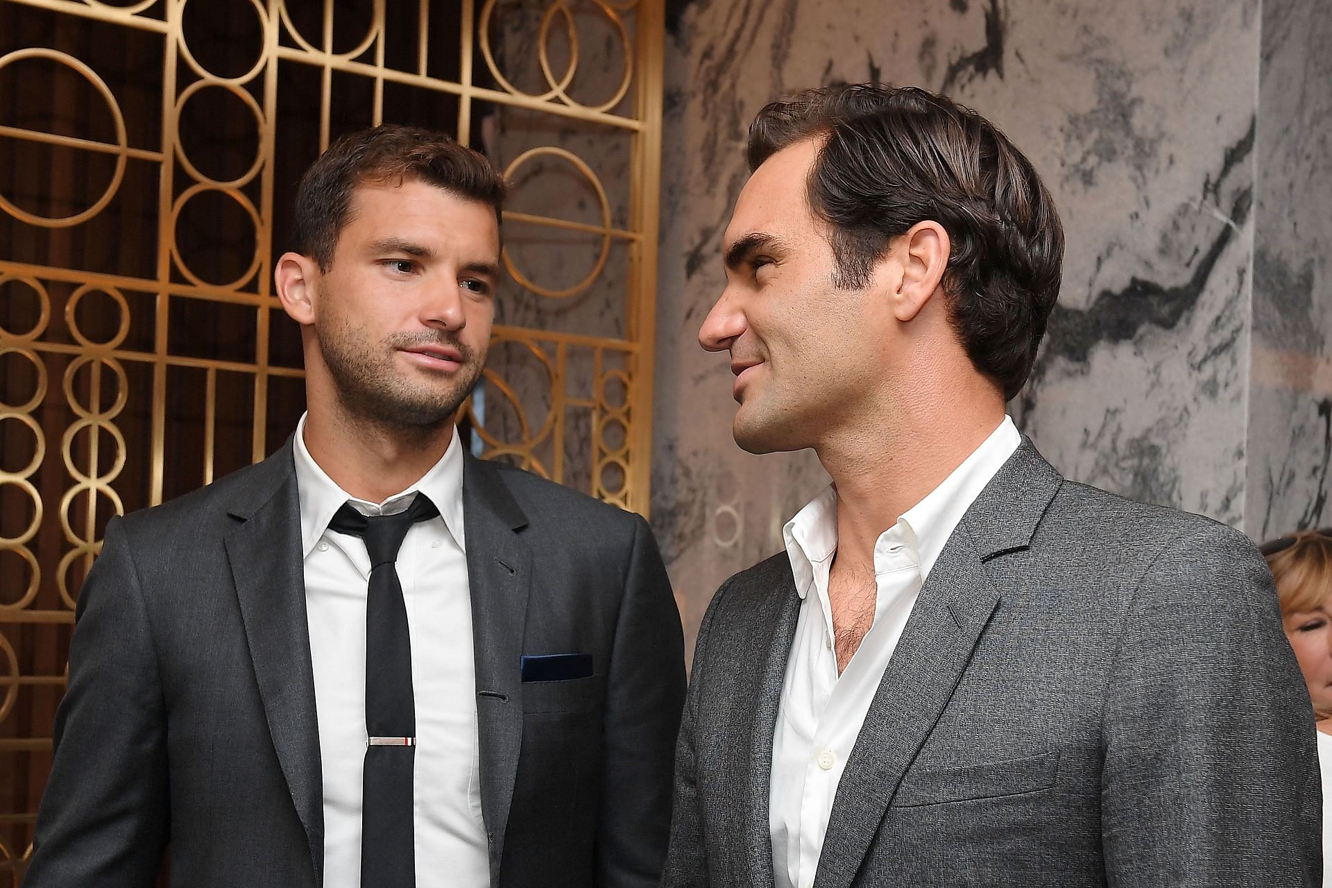 Dimitrov alongside Roger Federer
