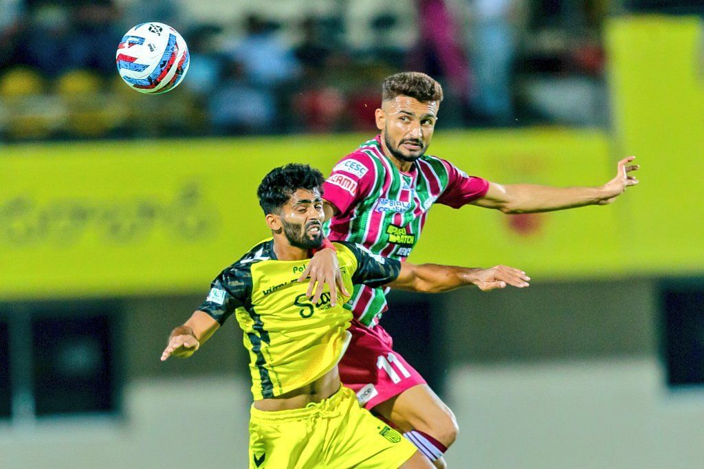 Hyderabad FC and ATK Mohun Bagan players fighting for the ball.