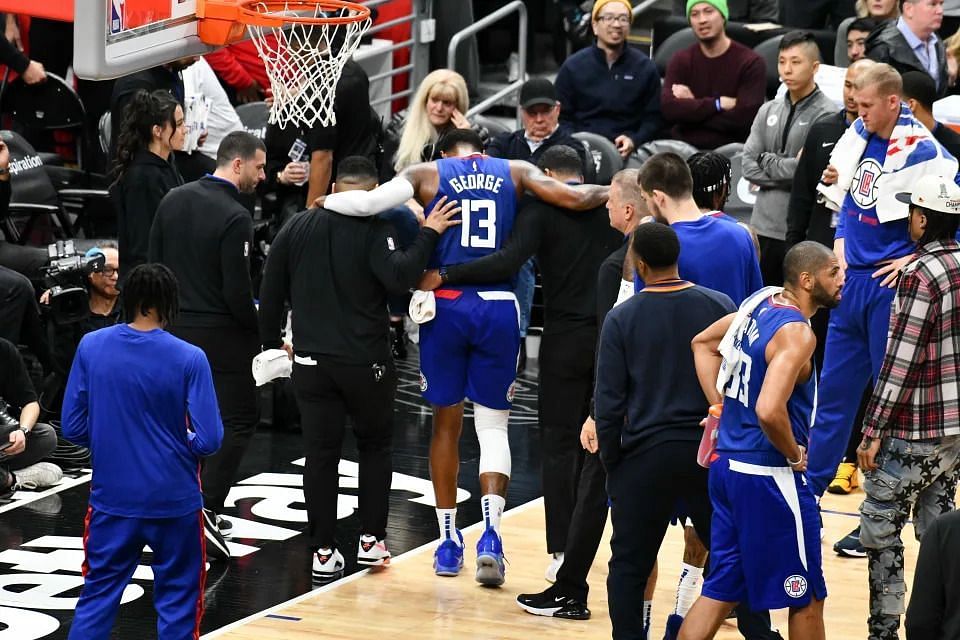 LA Clippers star wing Paul George being helped off the court following an apparent right leg injury on Tuesday night