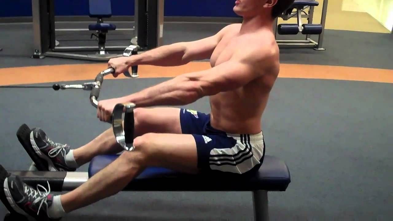 The low-row machine is a piece of exercise equipment consisting of a seat, footplates, and a handle attached to a cable and weight stack. (ScottHermanFitness/ Youtube)