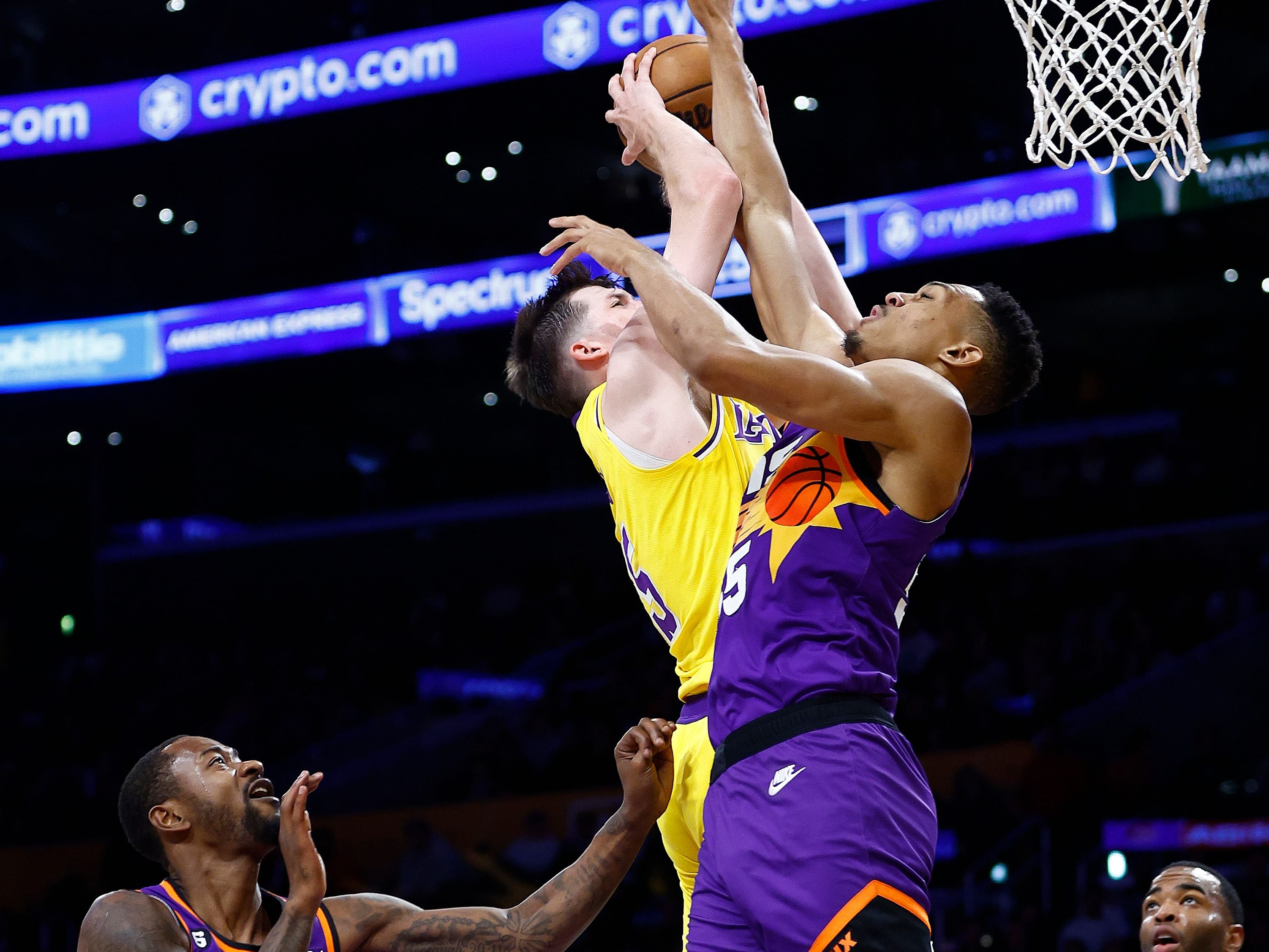 Austin Reaves attempts score over a Suns defender