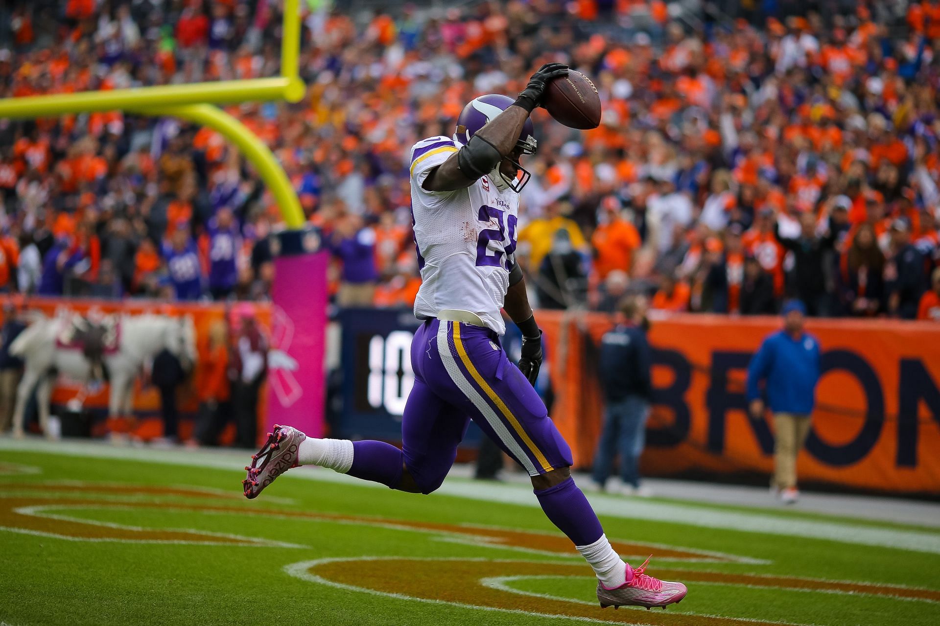 Adrian Peterson #28 of the Minnesota Vikings celebrates after rushing for a 48 yard touchdown against the Denver Broncos