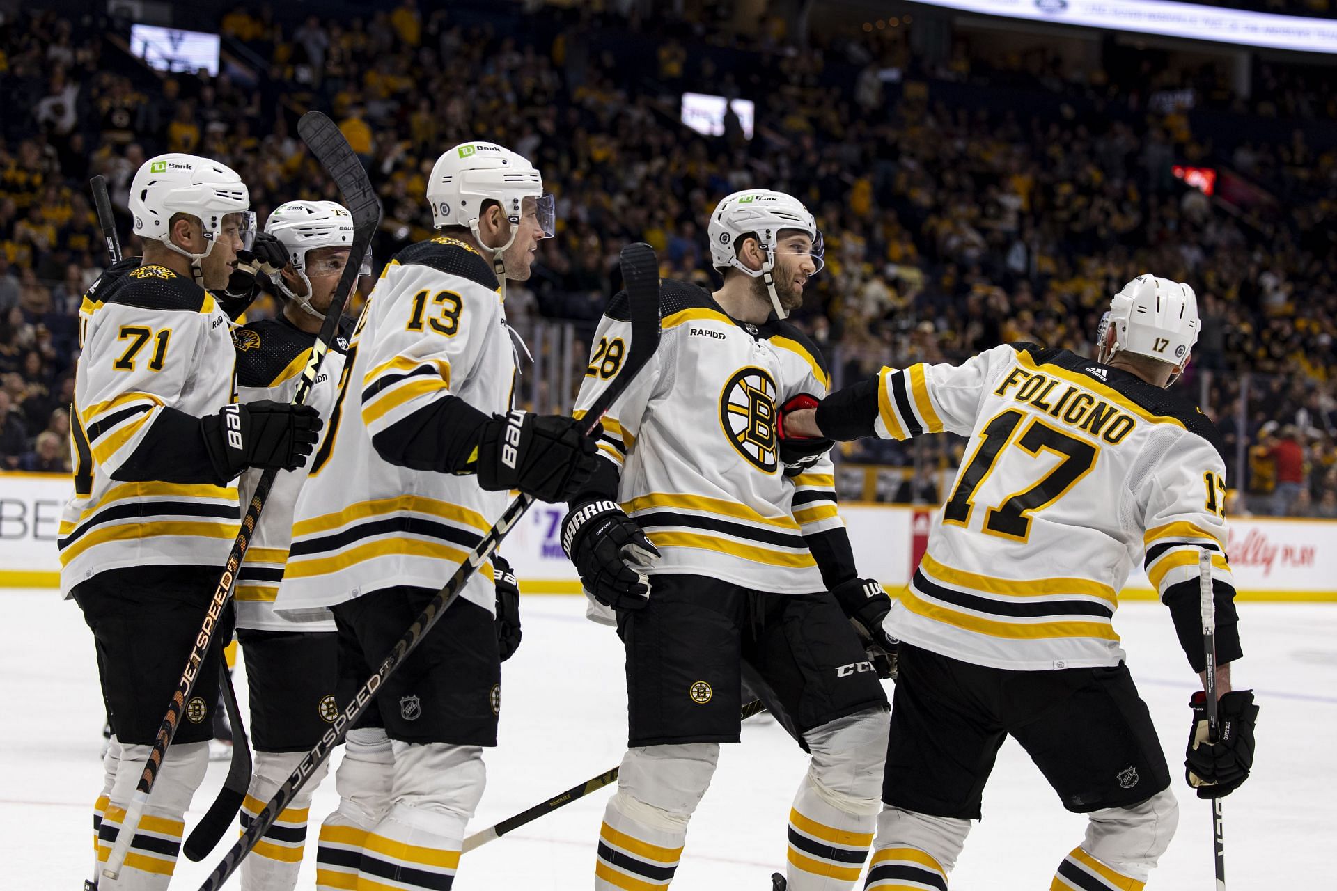 Boston Bruins players celebrate a goal against the Nashville Predators.