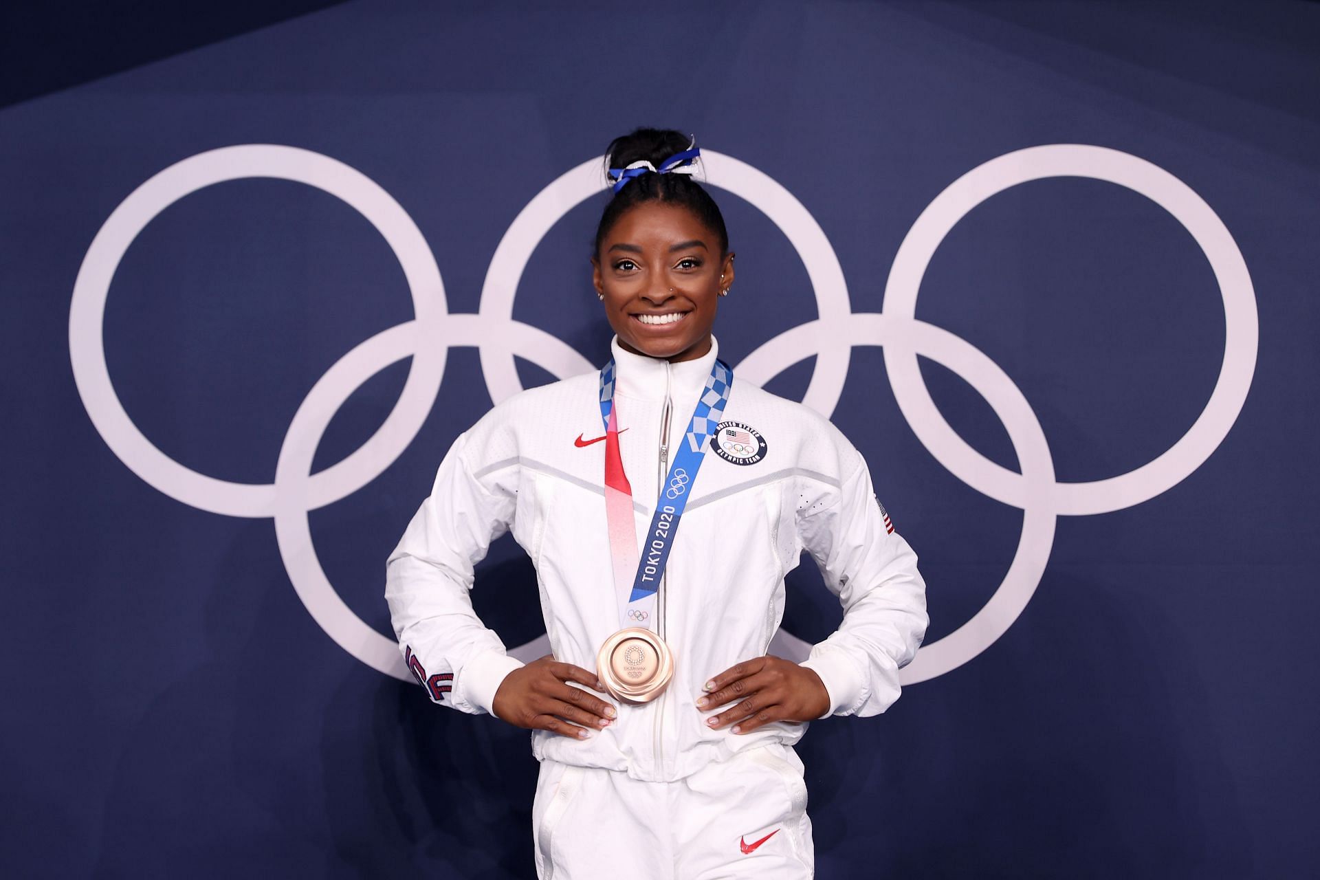 Simone Biles poses with the bronze medal at the Tokyo 2020 Olympic Games