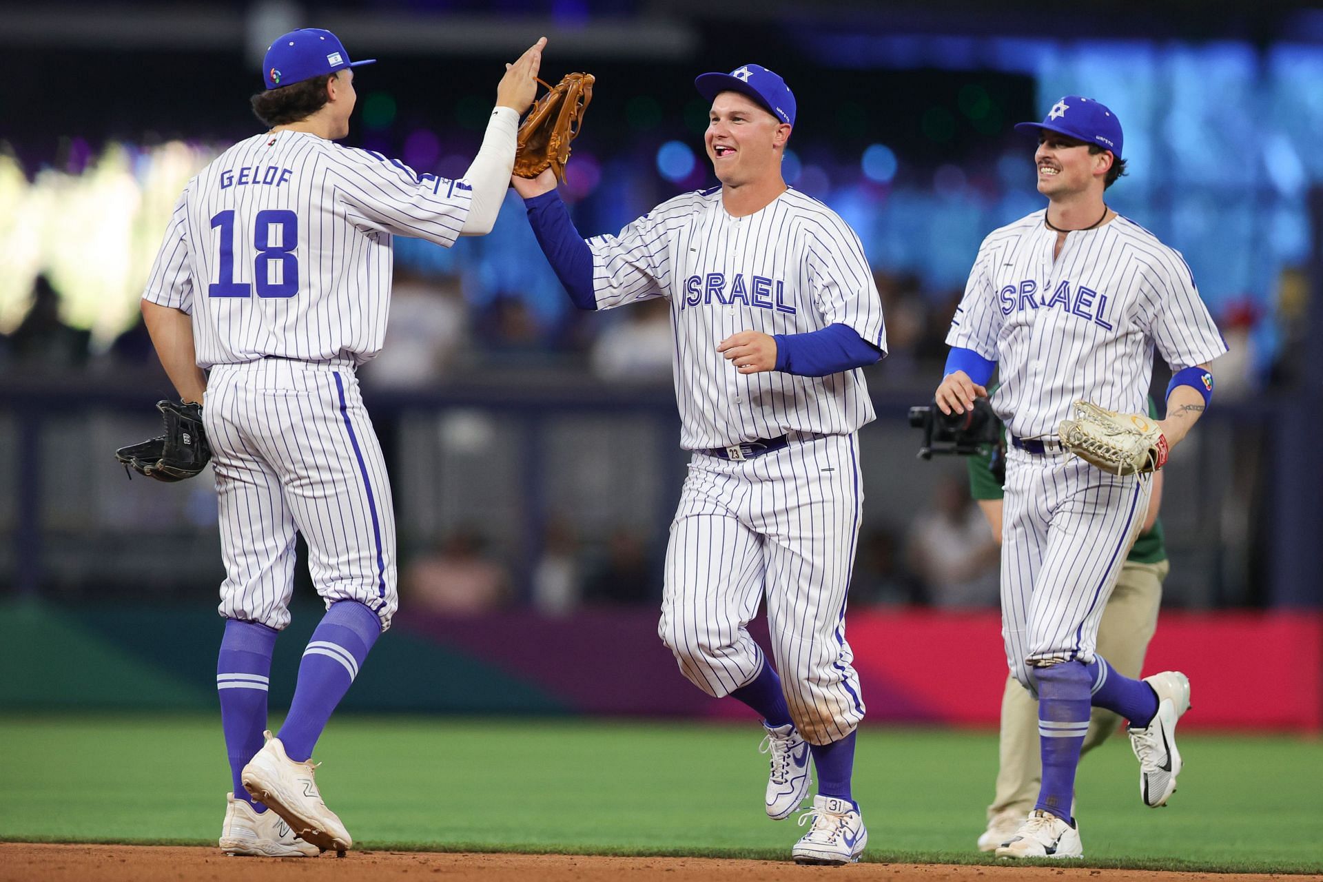 Zack Gelof (18) and Joc Pederson of Team Israel high five after defeating Team Nicaragua.