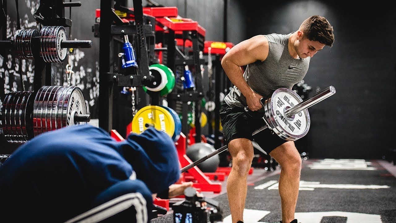  T Bar Row is an essential exercise that targets the back muscles, primarily the latissimus dorsi, rhomboids, and middle trapezius.  (Mind Pump TV/ Youtube)