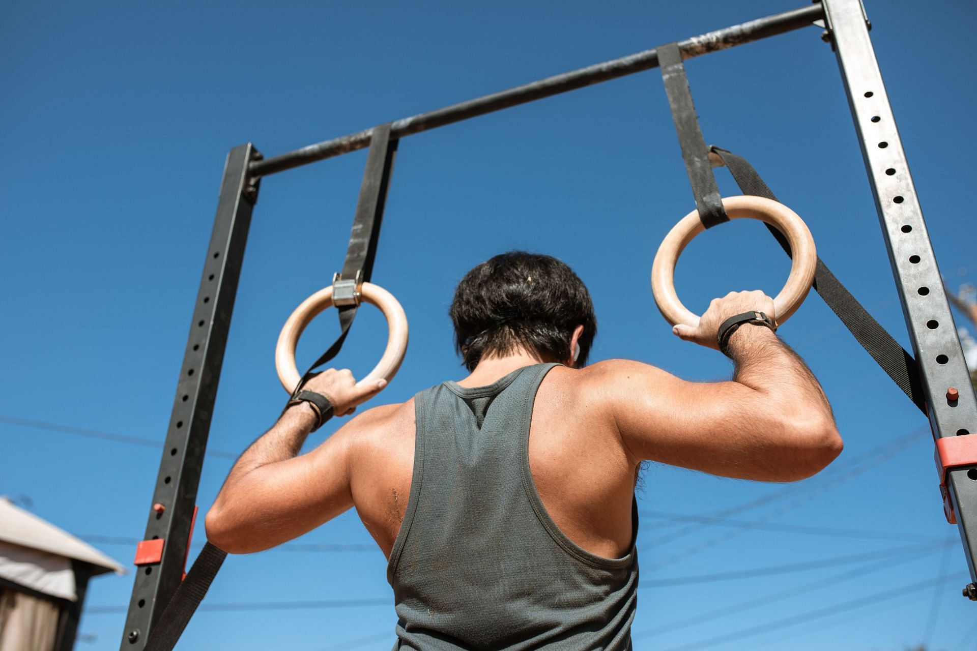 Pull-ups are a great exercise for building the shoulders and back (Image via Pexels/Rodnae Productions) )