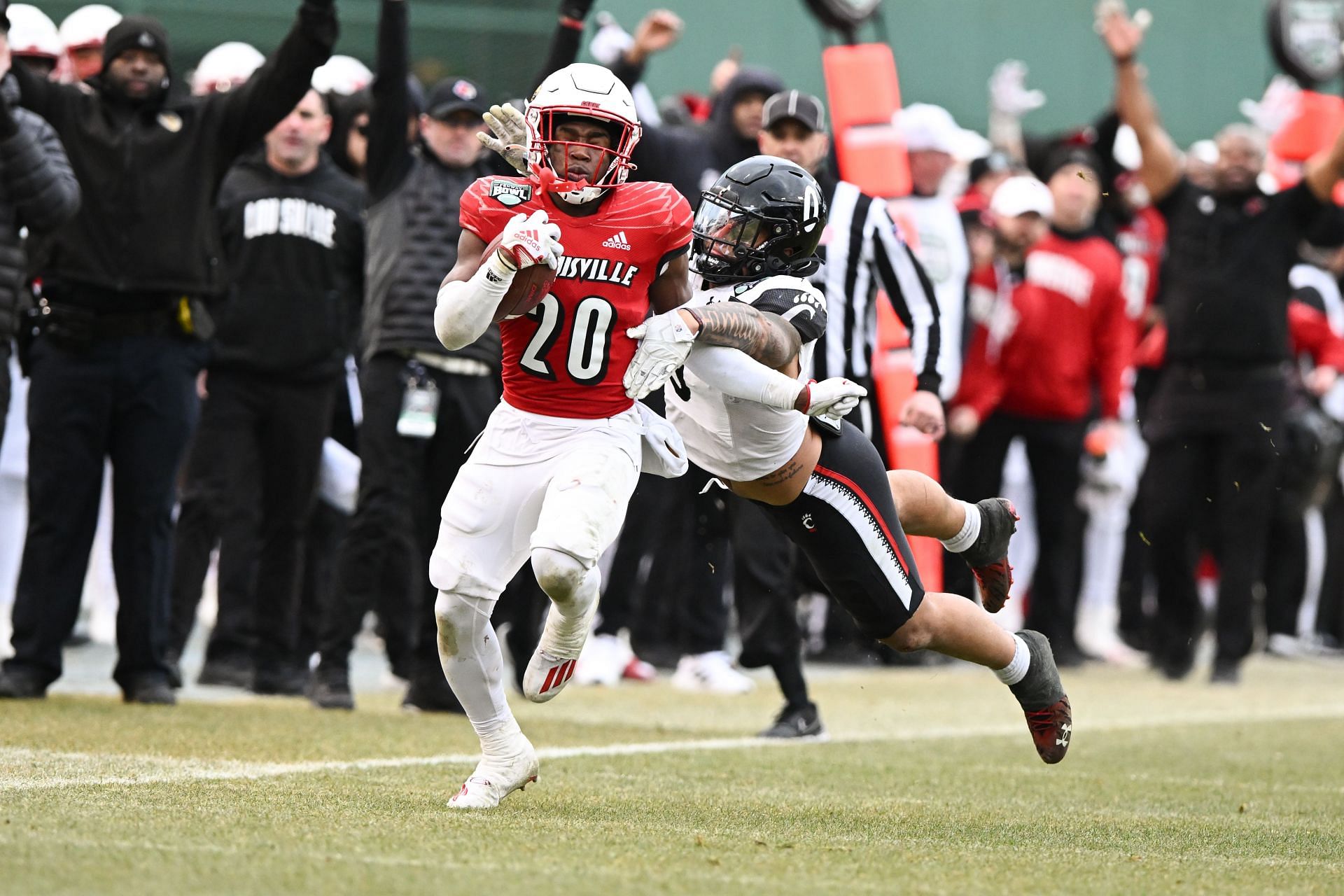 Maurice Turner #20 of the Louisville Cardinals breaks a tackle from linebacker Ivan Pace Jr. #0 of the Cincinnati Bearcats