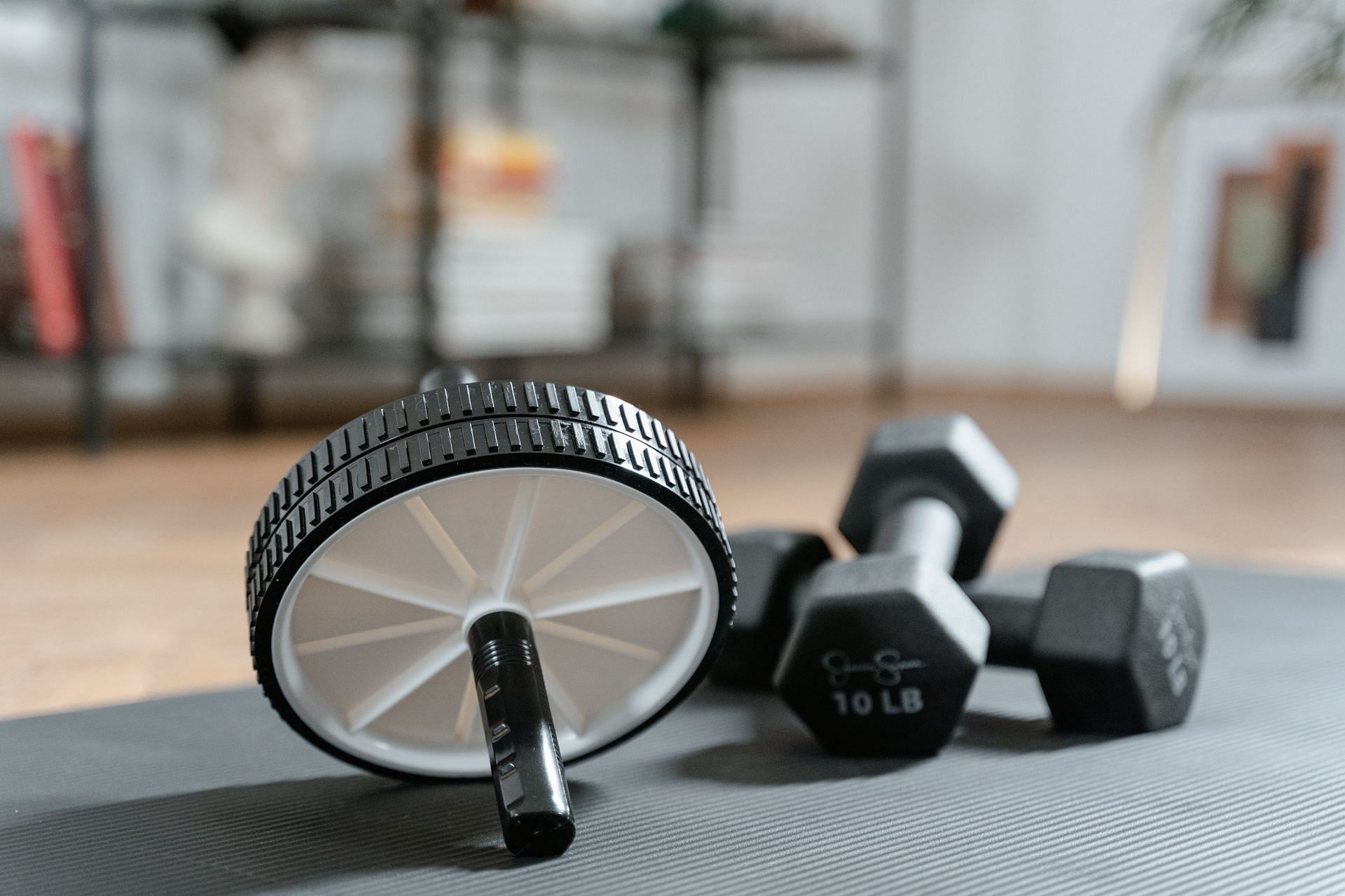 Rolling ab wheel helps in getting strong core. (Image via Pexels/ Mart Production)