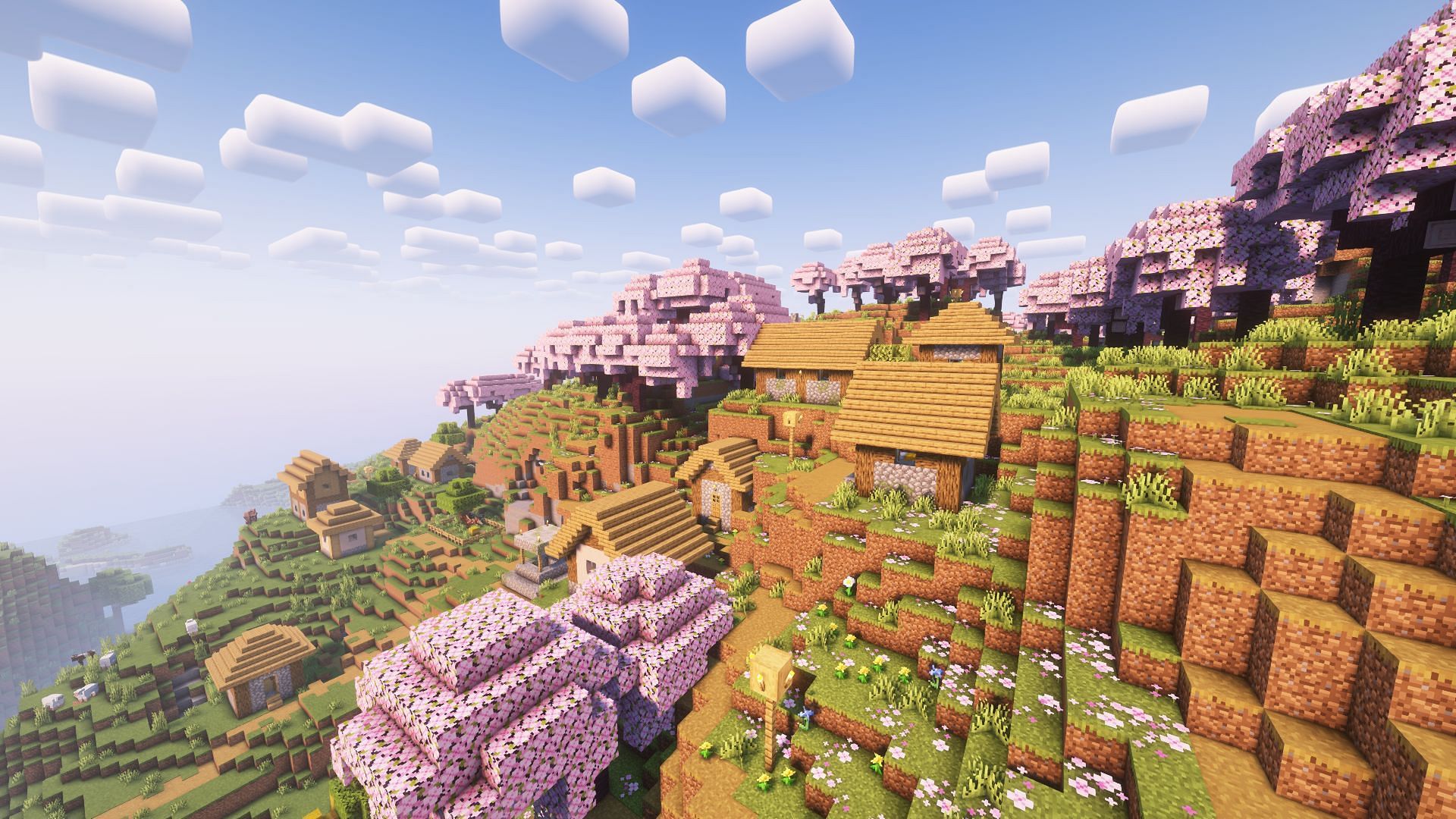 A village on the side of a mountain with cherry groves (Image via Mojang)