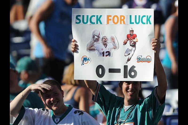 Fans with the &quot;suck for luck&quot; poster