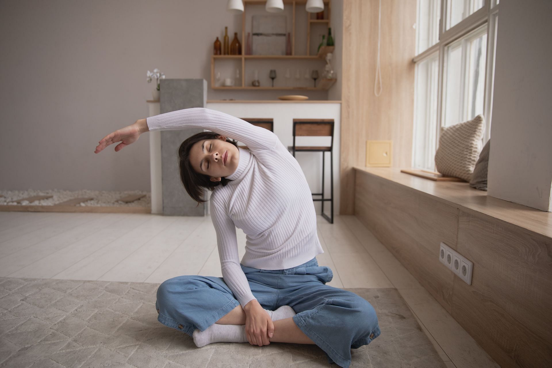 Stretching can be done while sitting or standing. (Image via Pexels/ Ekaterina Bolovtsova)
