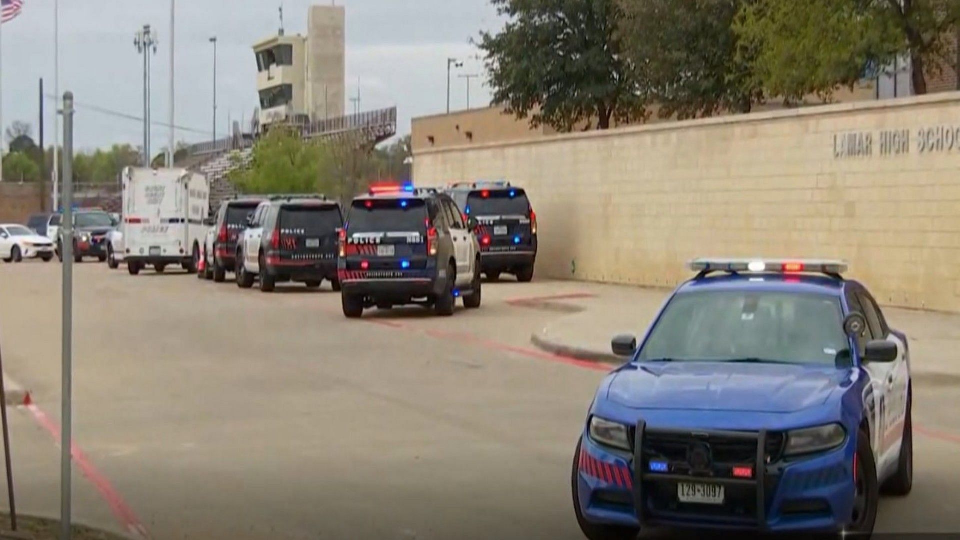 Police vehicles parked outside Lamar High School after a school shooting on Monday (Image via K-12 school shooting/Twitter)