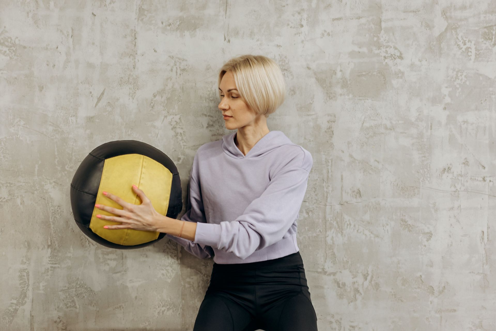 Wall ball exercises target your abdominals as well as arm muscles. (Image via Pexels/ Mikhail Nilov)