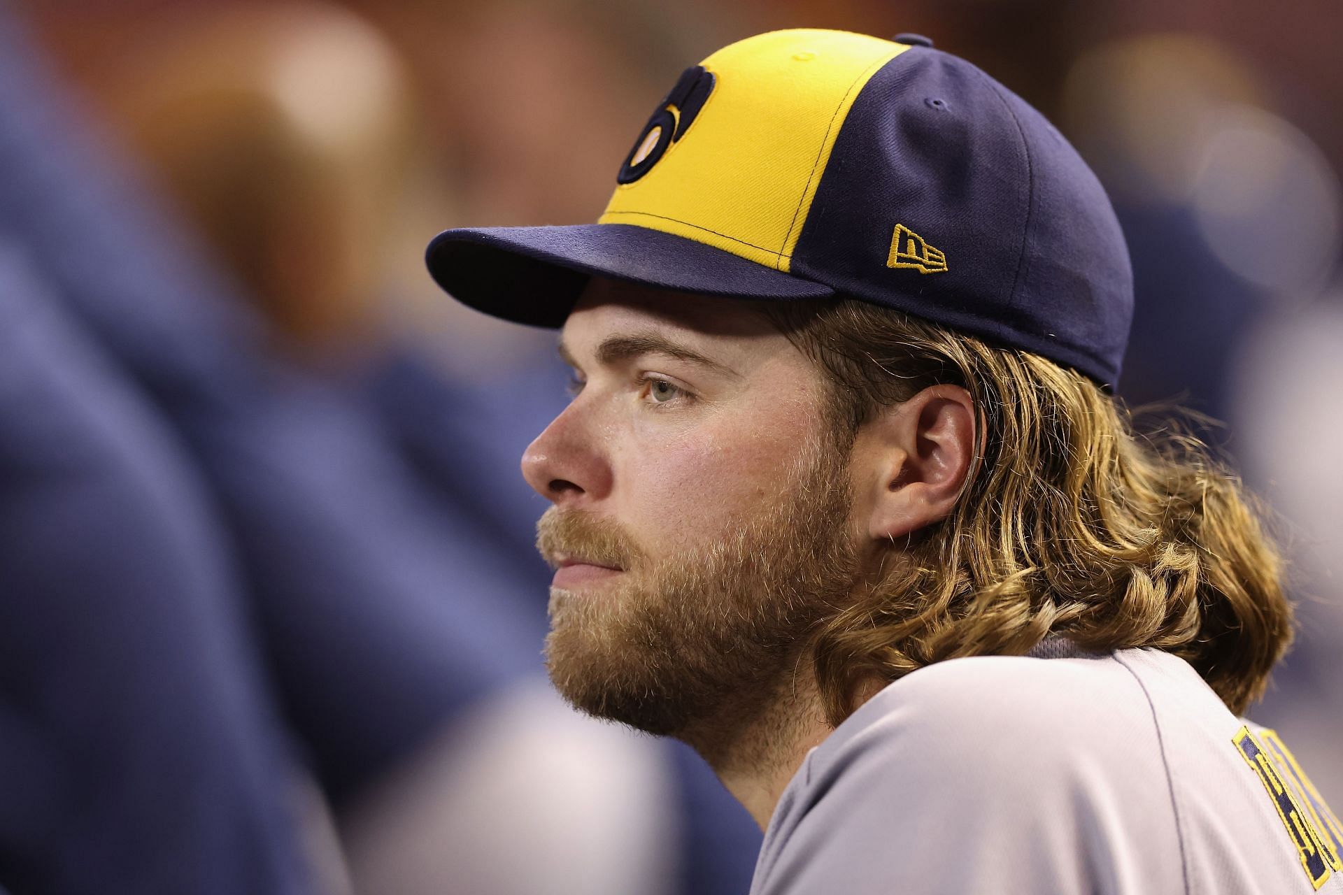 Starting pitcher Corbin Burnes of the Milwaukee Brewers watches from the dugout at Chase Field