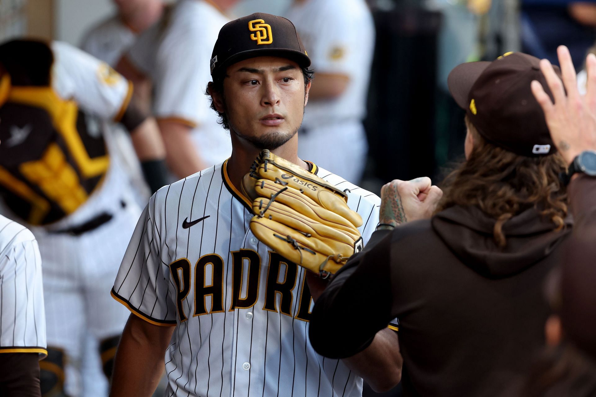 Yu Darvish of the San Diego Padres poses for a photo with a fan
