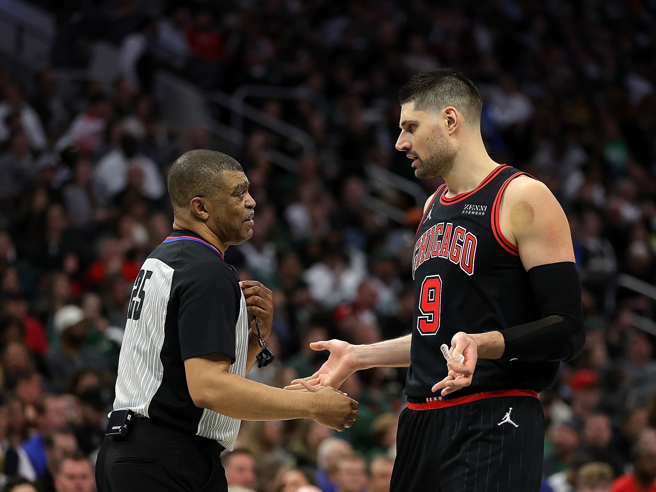 NBA referee Tony Brothers and Nikola Vucevic of the Chicago Bulls