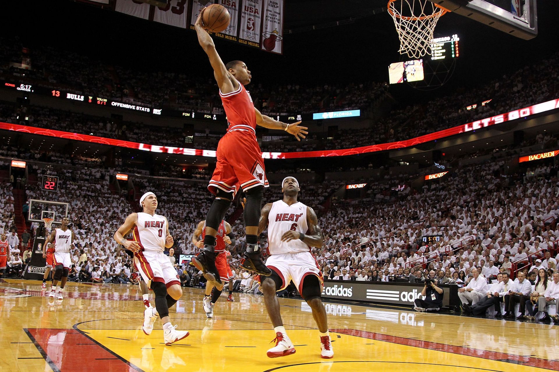  Derrick Rose #1 of the Chicago Bulls dunks against LeBron James #6 and Mike Bibby #0 of the Miami Heat 