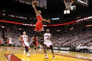 Derrick Rose #1 of the Chicago Bulls dunks against LeBron James #6 and Mike Bibby #0 of the Miami Heat