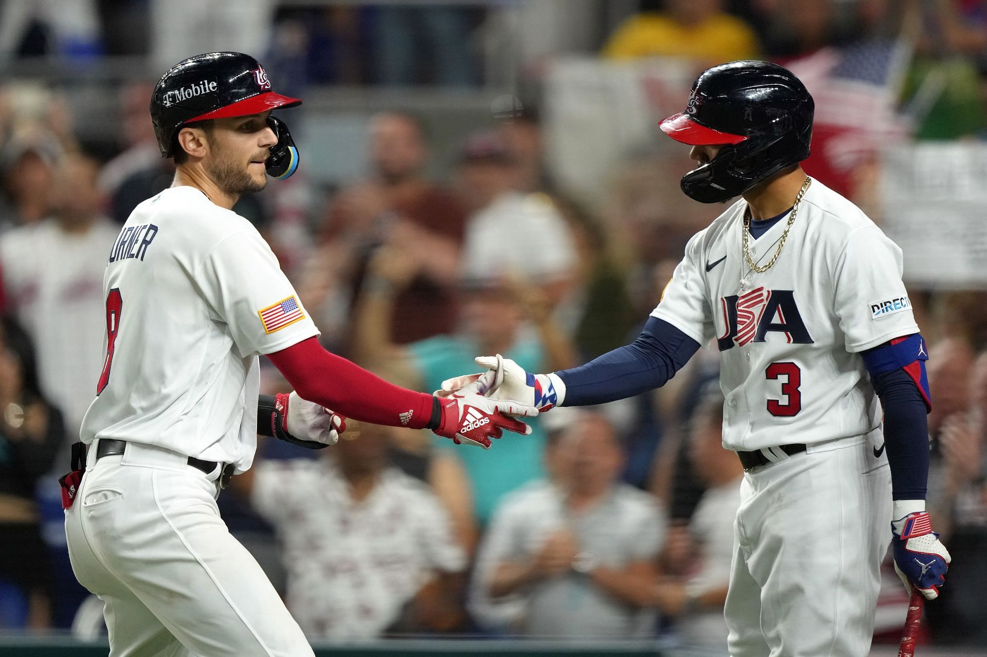 Trea Turner #8 of Team USA shakes hands with Mookie Betts #3 after hitting a solo home run in the second inning against Team Cuba