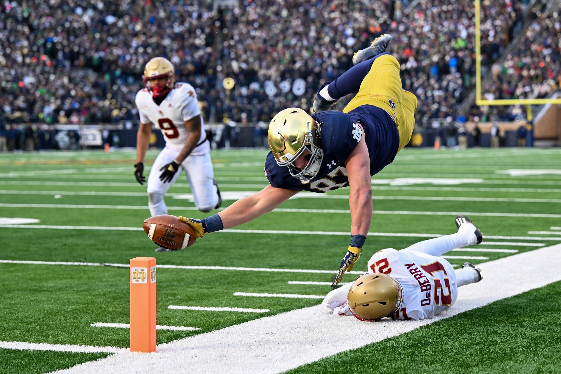 Michael Mayer #87 of the Notre Dame Fighting Irish dives just short of the touchdown in the first half against Josh DeBerry #21 of the Boston College Eagle