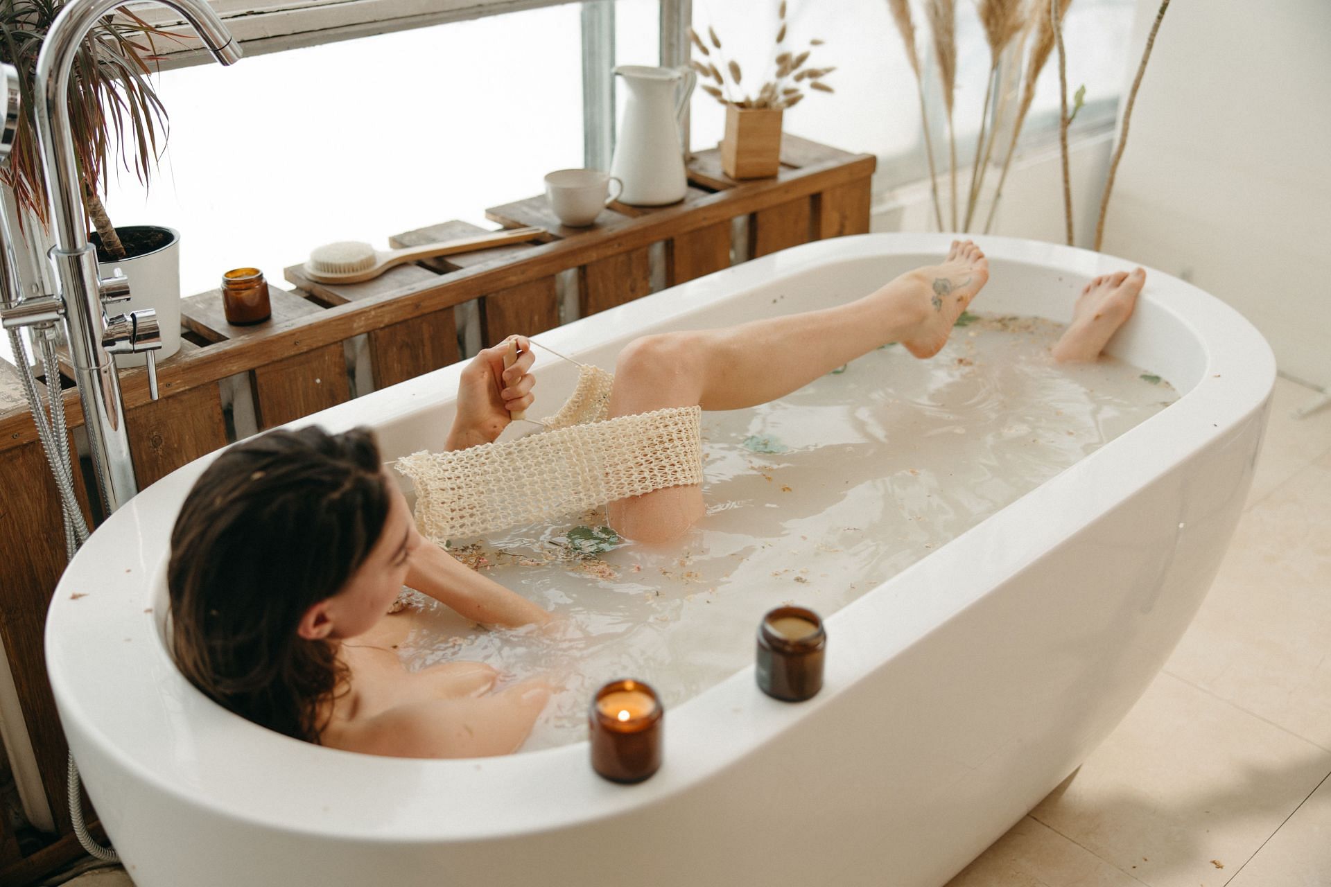 How to remove tan: Taking a bath can help reduce tan from tanning products (Image via Pexels/Yaroslav Shuraev)
