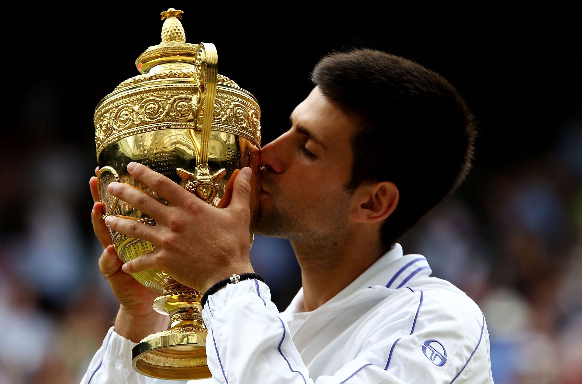 The Serb lifts the Wimbledon trophy in 2011